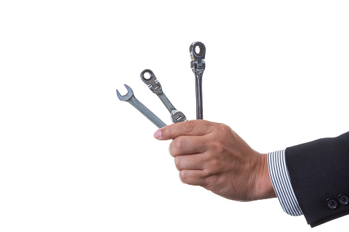 Mechanic engineer holding two ratchet box end wrench and open end wrench in his hand; handing tool on white background with clipping path