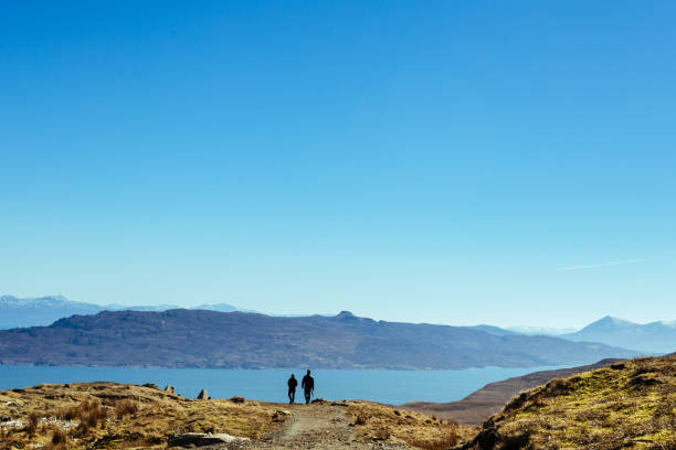 istock Couple walking along the trail in hills 1061089474