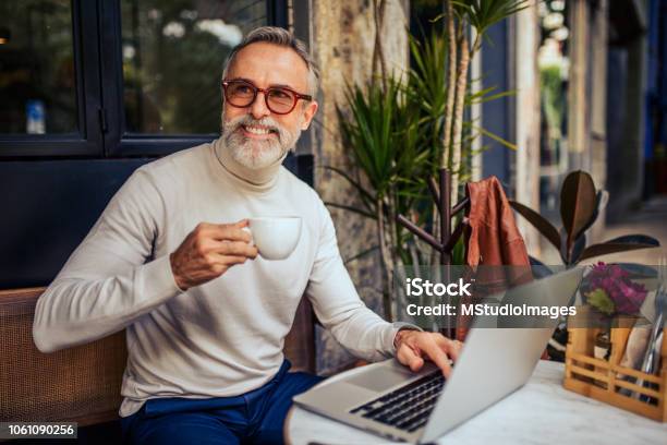 Handsome Mature Adult Relaxing At The Bar Stock Photo - Download Image Now - 50-59 Years, Coffee - Drink, Decisions