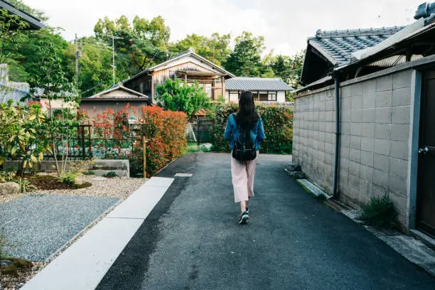 Photo of traveler relaxing walking through the garden