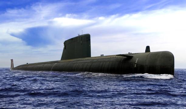 istock Naval submarine on open sea surface with cloudy blue sky 1061122098