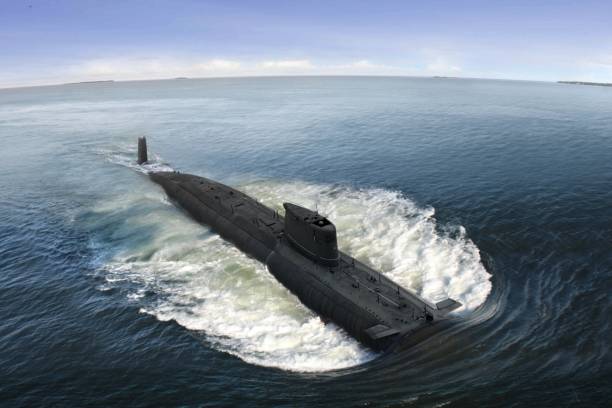 istock Naval submarine on open sea surface with cloudy blue sky 1061122100