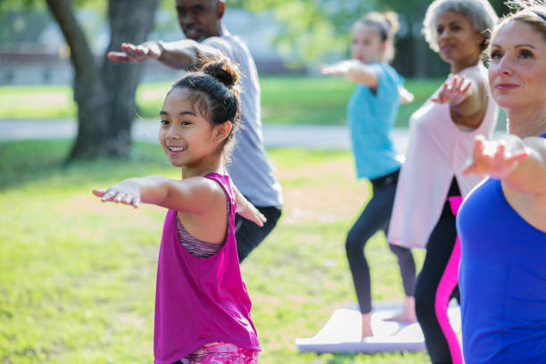 istock Children and adults taking outdoor yoga exercise class 1061126034