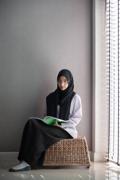 istock Muslim student reading book at room. 1061127624