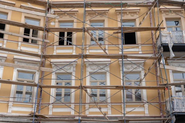 istock Scaffold on house, renovation. Scaffolding on building, beige wall and window 1061134234