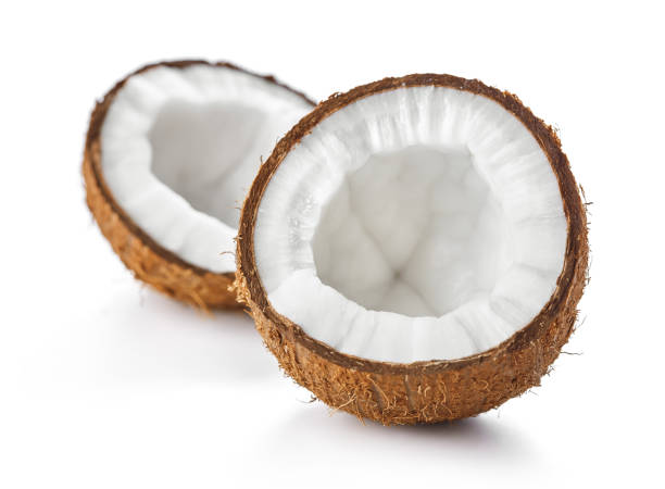 cracked coconut isolated halves of cracked coconut isolated on white background cocos stock pictures, royalty-free photos & images