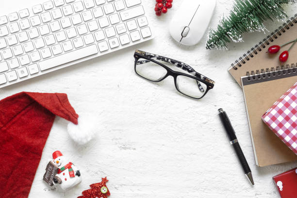 istock Merry Christmas Festival.  Flat lay Office desk table with computer wireless mouse and keyboard and Christmas decoration toys and ornaments on rustic white wooden background. Top view with copy space. 1061140864