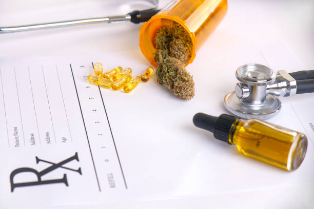 Assorted cannabis products, pills and cbd oil over medical prescription sheet - fotografia de stock