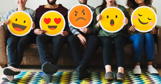 istock Group of diverse people holding emoticon icons 1061153094