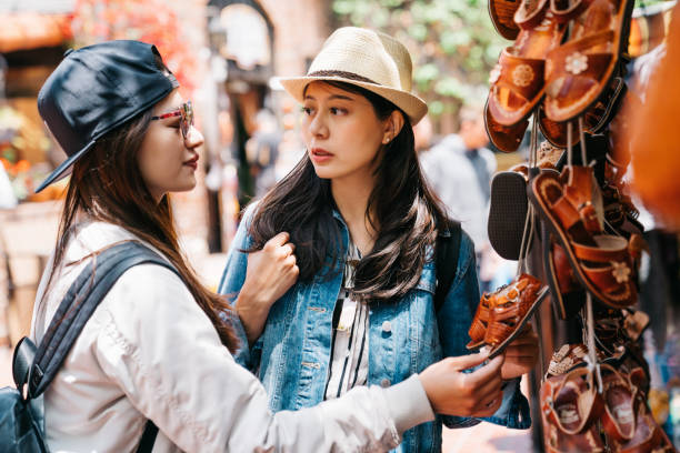 istock women looking at the cute leather shoes 1061153126