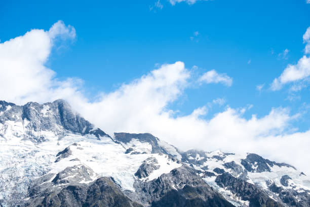istock Stunning snow on the rocky mountain with blue sky and white clouds. 1061154028