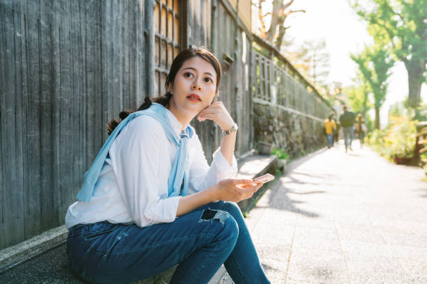 istock pretty lady sitting beside the street 1061155696