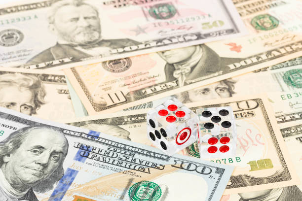 istock Two dice and dollar bank note concept for risk in investment 1061166562