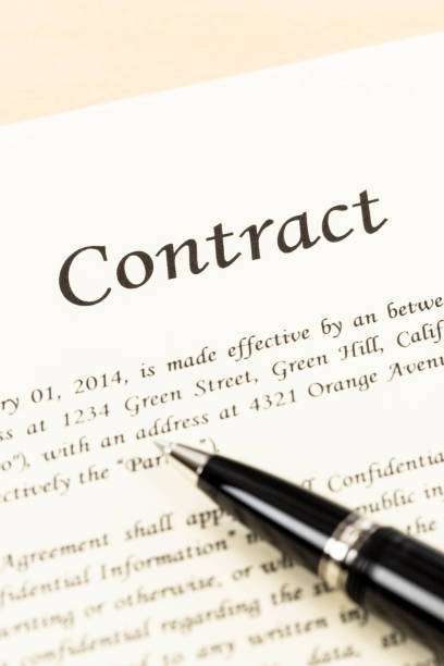 istock Business contract document on cream color paper and pen 1061166570