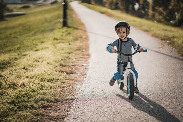 istock Cute small boy riding balance bicycle in nature. 1061167016