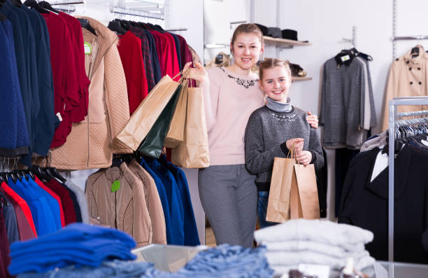 istock Joyful woman with daughter holding many bags 1061178956