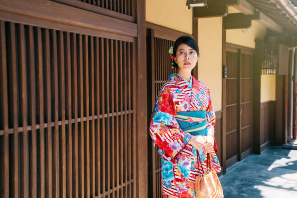 istock girl wearing kimono standing in front house 1061179560