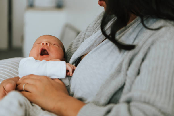 istock Mother holding her infant baby 1061186784