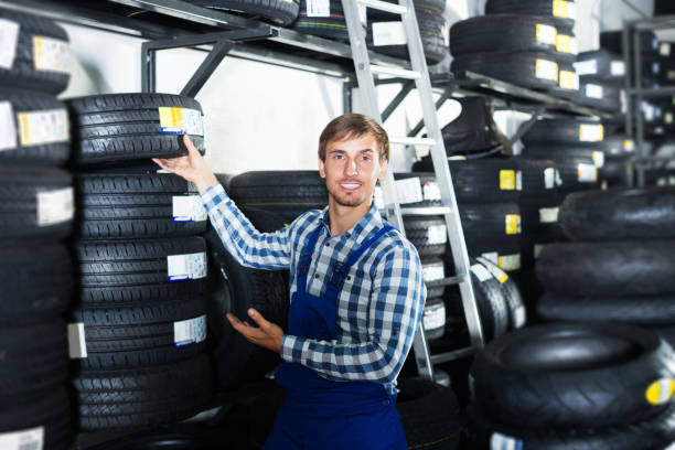 istock Man standing with auto tires 1061187226