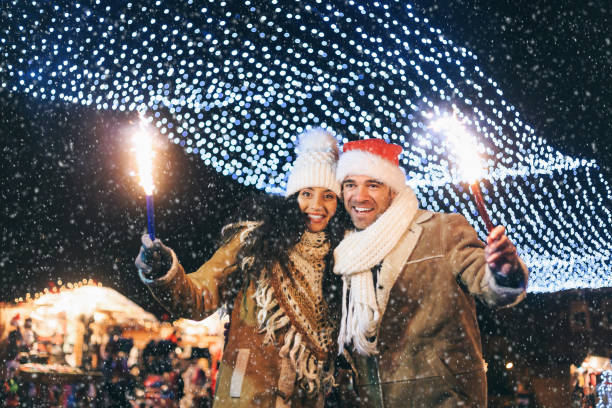 istock Young couple having fun with sparkling candles at night 1061188908