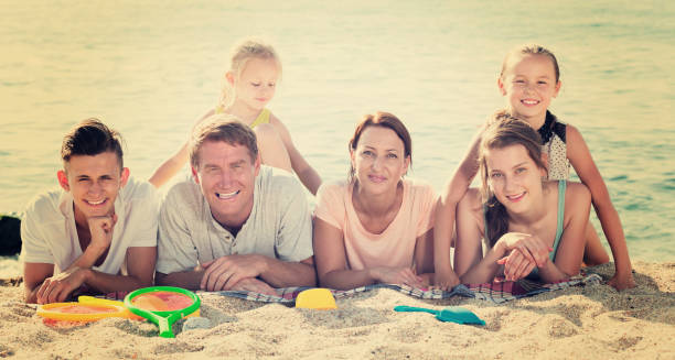 istock Smiling family on sandy beach 1061189888