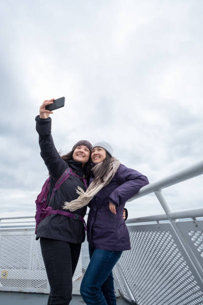 istock Multi-Ethnic Teen Sisters Pose for Selfie on Outside Ferry Deck 1061191902