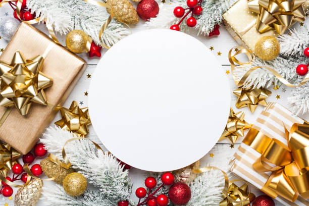 istock Christmas mockup with gift or present boxes, snowy fir tree and holiday decorations on white wooden table top view. 1061196346