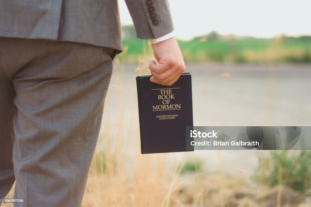 Book of Mormon Missionary holding book of mormon Mormonism Stock Photo
