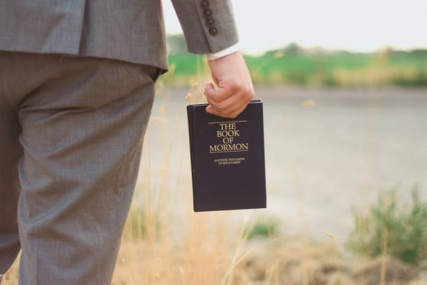 Book of Mormon Missionary holding book of mormon mormonism stock pictures, royalty-free photos & images