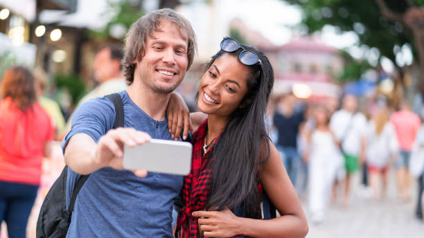 istock Tourists enjoying vacations and taking selfie 1061197724