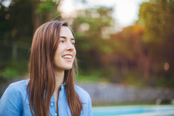 Smiling beautiful woman looking away at park