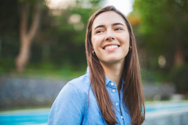 istock Smiling woman looking away at park 1061198152