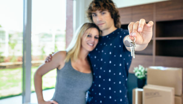 istock Moving couple showing keys 1061198418