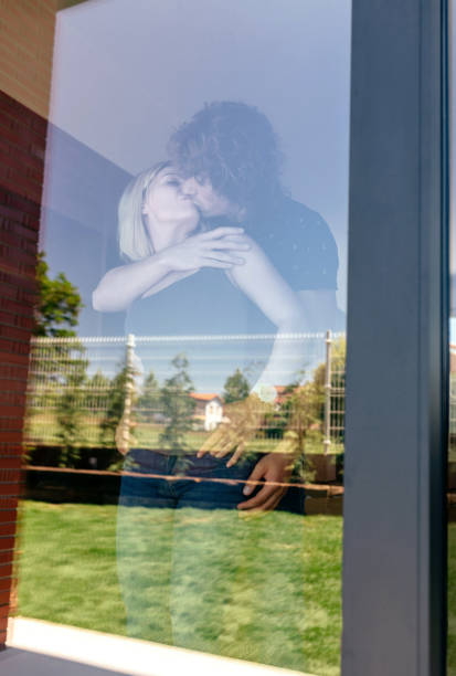 istock Couple kissing behind the window 1061198422