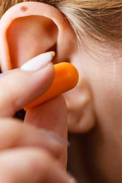 istock Woman putting earplugs 1061198462