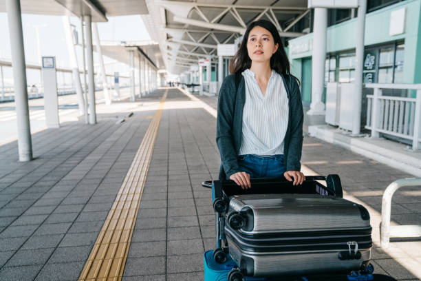 istock elegant tourist pushing suitcase trolley 1061198540