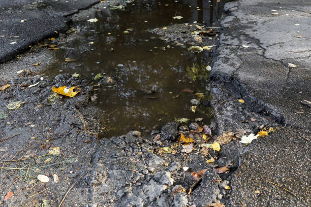istock large pit with stones on the asphalt road 1061198702