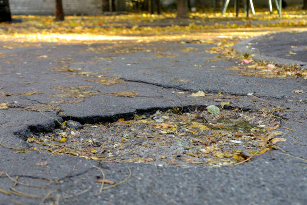 istock large pit with stones on the asphalt road 1061198724