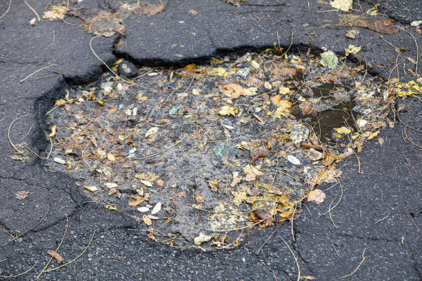 istock large pit with stones on the asphalt road 1061198726
