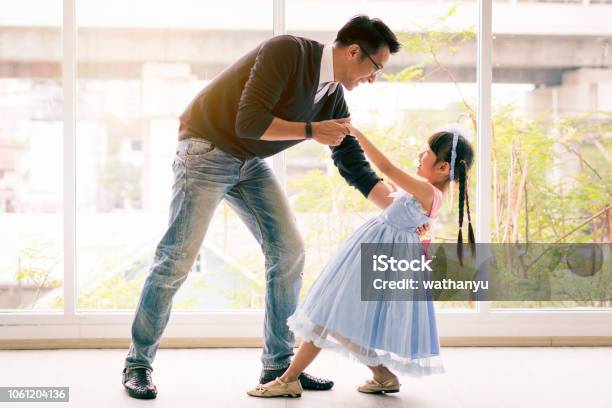 Cute Little Girl Is Dancing With Her Daddy Having Fun At Home Together Concept Stock Photo - Download Image Now