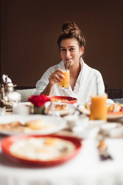 istock woman at the table for the buffet breakfast with fruit 1061204826