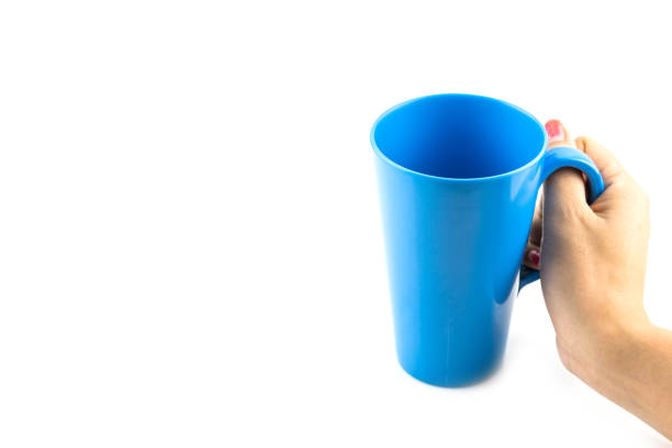 istock Woman Hand with blue cup of tea isolated 1061207886