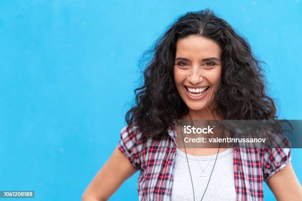 Portrait Of Smiling Mature Women On Blue Background Stock Photo - Download Image Now