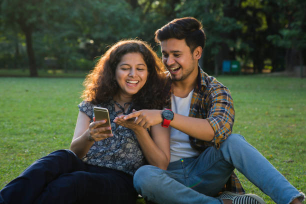istock Couple Sitting In park - Stock image 1061210754