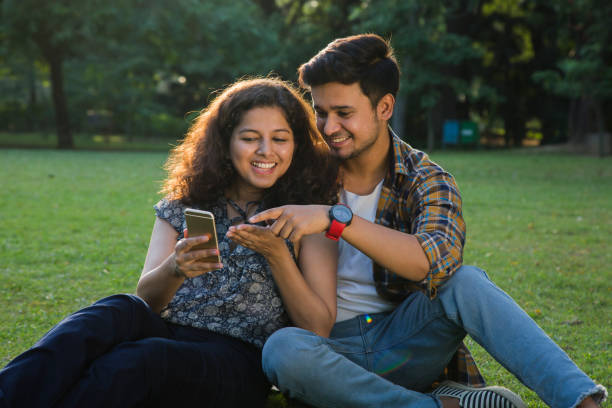 istock Couple Sitting In park - Stock image 1061212558