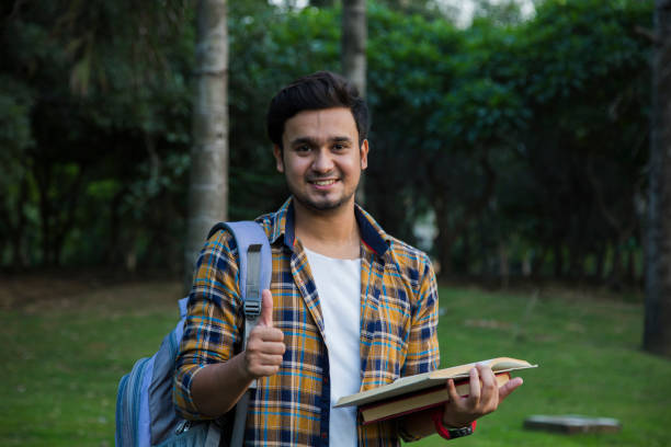 istock Male college student with books outdoors - Stock image 1061212964
