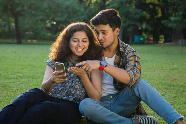 istock Couple Sitting In park - Stock image 1061216726