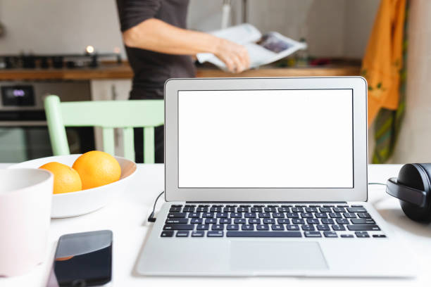 istock Laptop and smartphone on the kitchen table 1061219114