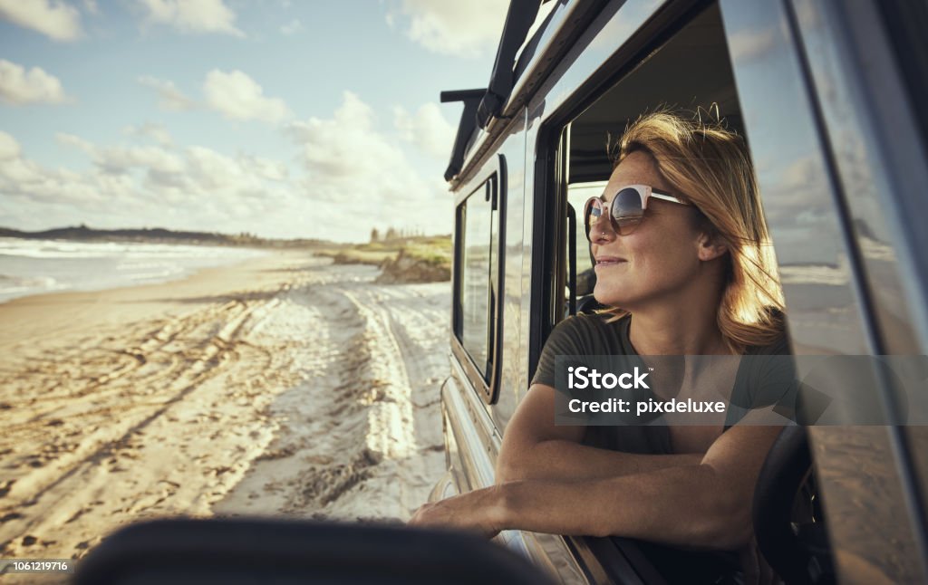 This is my kind of happy place! Cropped shot of a woman out on a road trip Australia Stock Photo