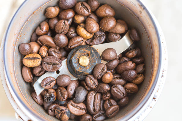 istock Fried coffee beans in a coffee grinder. Macro 1061221312